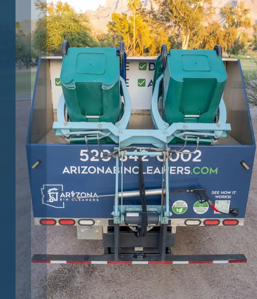 Rear view of Arizona Bin Cleaners truck with two green trash bins lifted for cleaning in Tucson, AZ