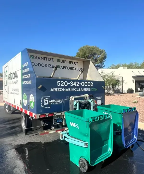 Arizona Bin Cleaners truck in a residential neighborhood actively cleaning two green trash bins curbside