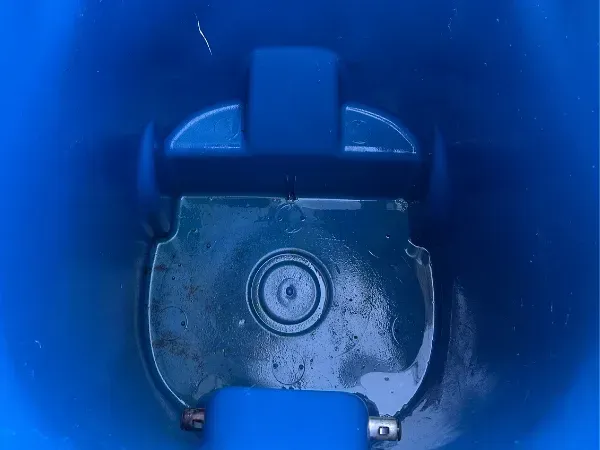 Inside view of a freshly cleaned blue trash bin with no visible debris or grime