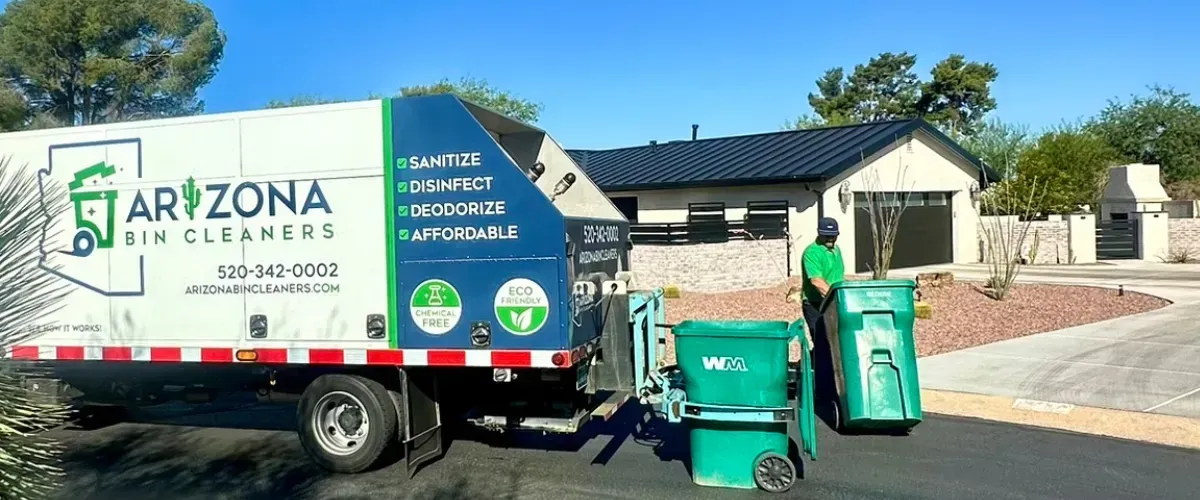 Technician from Arizona Bin Cleaners operates trash bin cleaning truck in front of a suburban home in Tucson, AZ.
