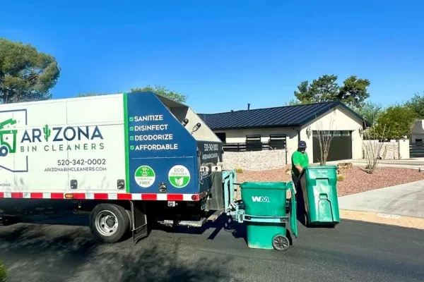 Arizona bin cleaning truck servicing curbside waste bins in a residential neighborhood.