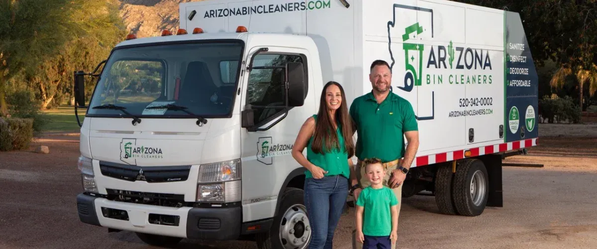 A family of three standing proudly beside a white Arizona Bin Cleaners truck