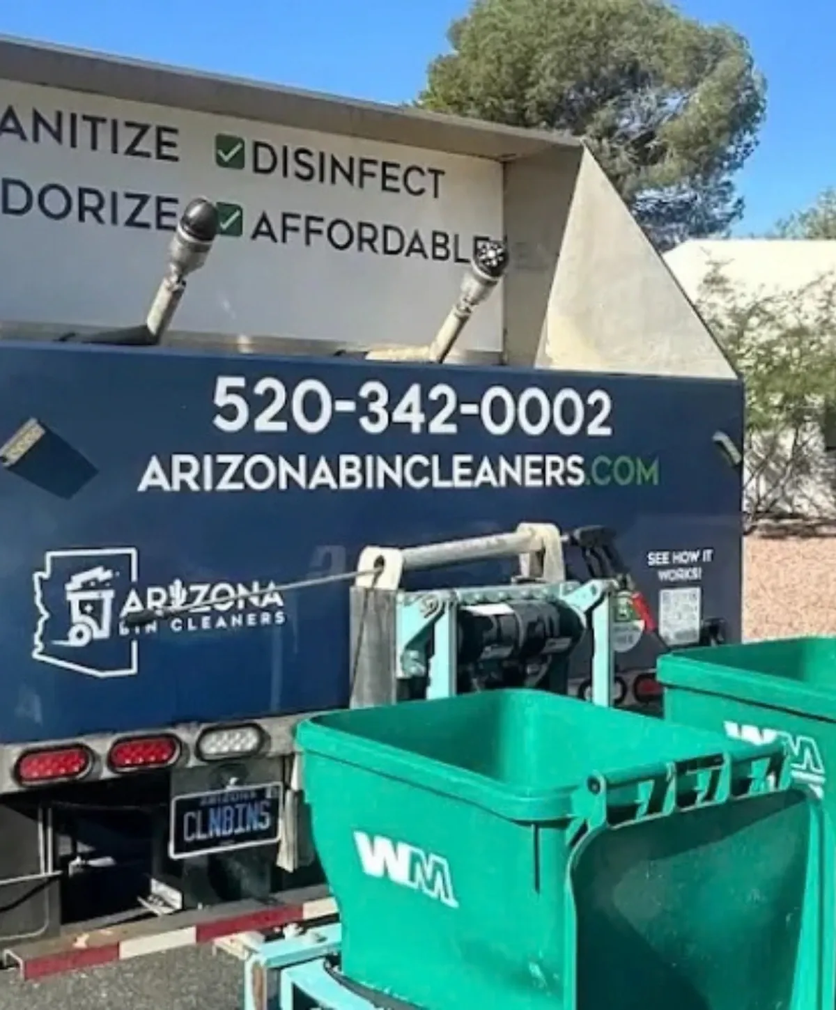 Rear view of an Arizona Bin Cleaners truck with green waste bins and service details.
