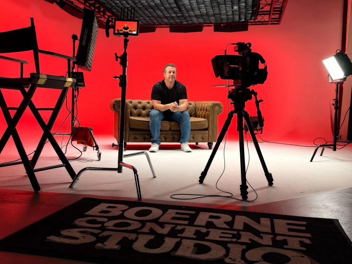 Boerne Content Studio video production set with camera, lighting, and red backdrop