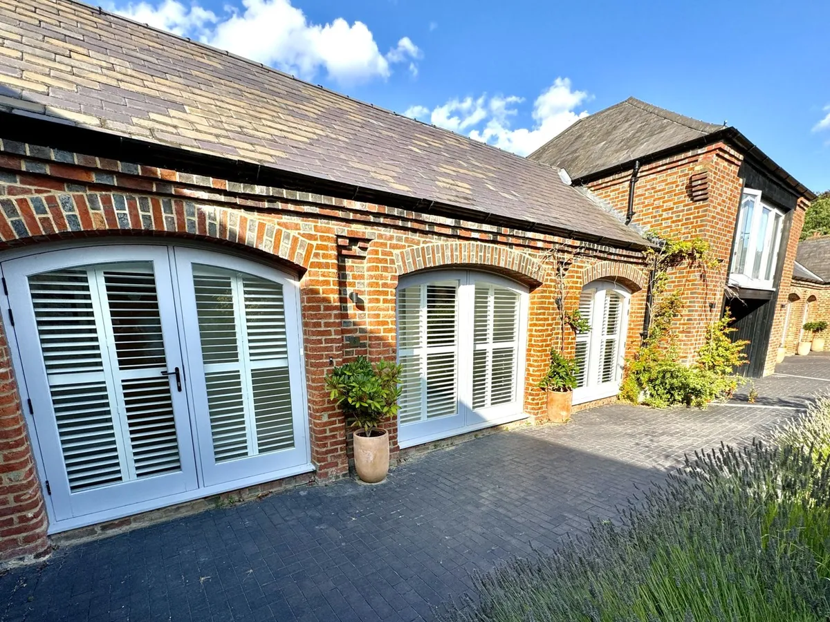 Special shape shutters seen from outside a home in Oxshott