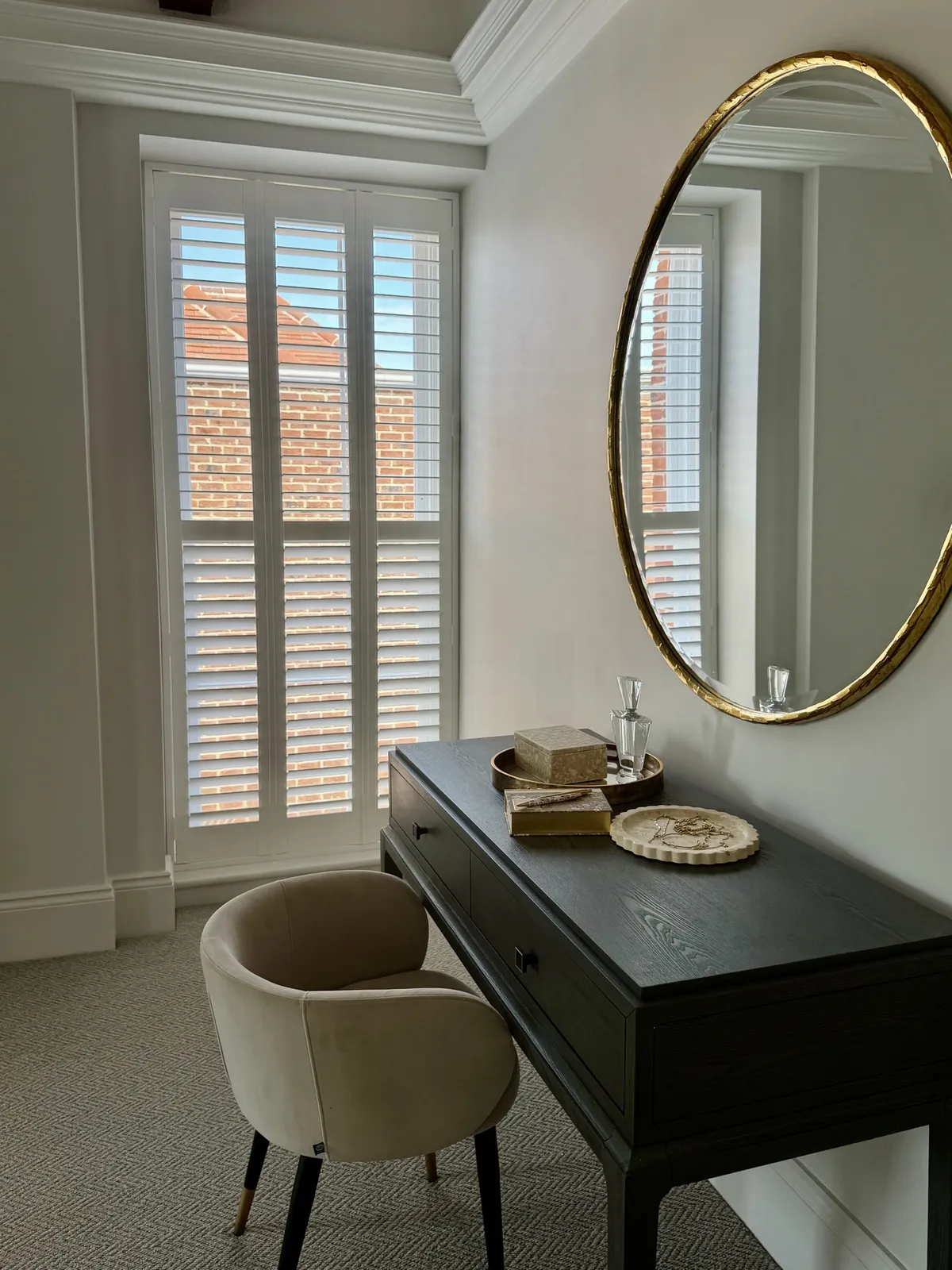 Full height white shutters in a dressing room