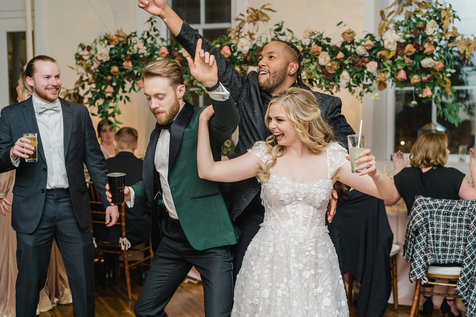 leeroy dancing with bride and groom on the dance floor.