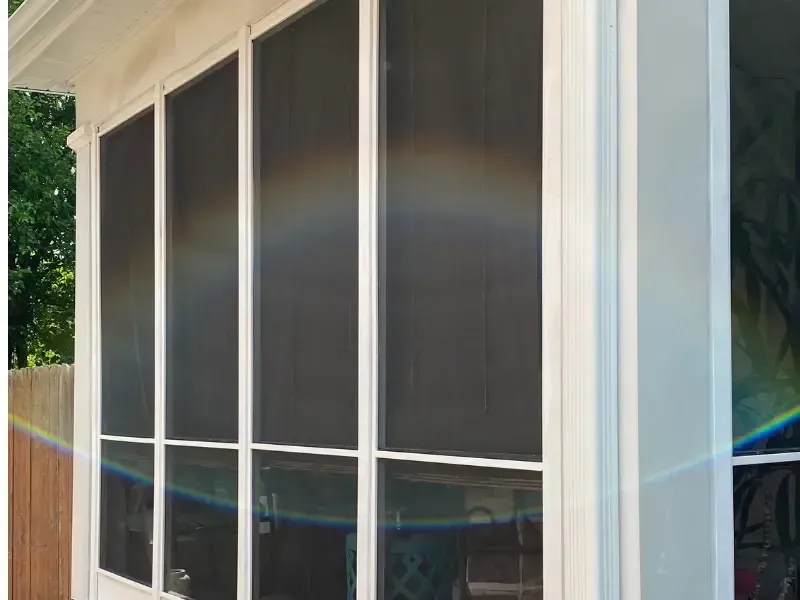 Close-up of screened porch mesh panels on exterior wall.