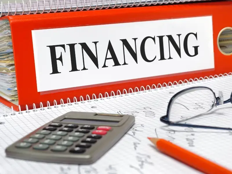 Financing binder with calculator, representing deck project financing options.