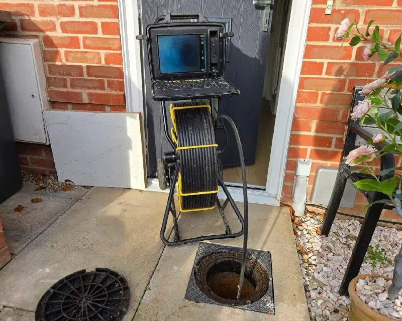 Drainage CCTV survey camera inspecting blocked drains in Bournemouth, positioned inside a manhole to identify blockages and pipe damage