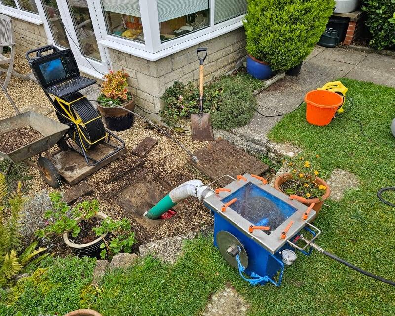 Installation of a CIPP liner in a residential garden to repair blocked drains in Bournemouth, showing modern trenchless drainage rehabilitation technology