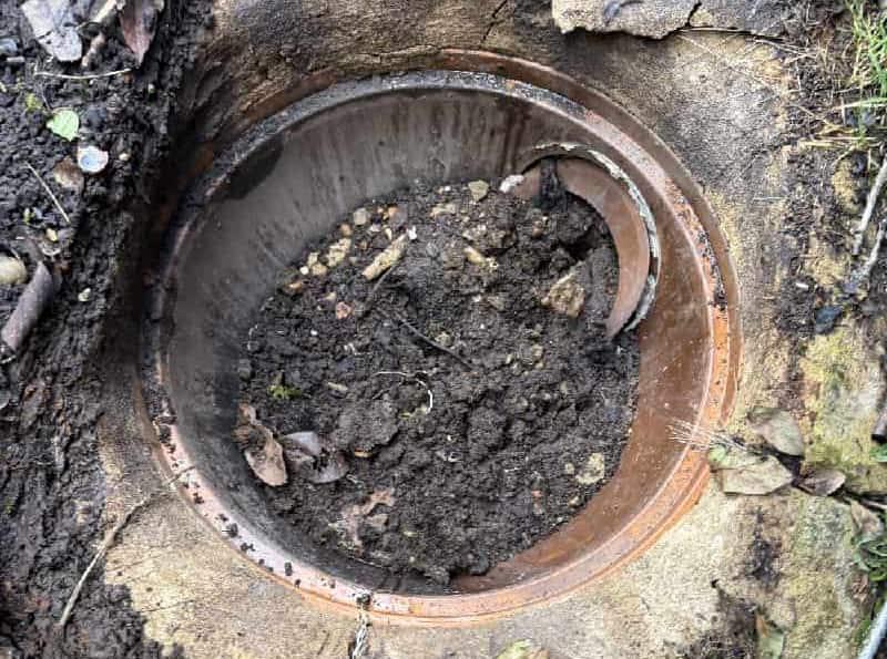 I'll help you create effective alt text that incorporates your keywords while following accessibility best practices. Here's the alt text for your second image: "Excavated dirt surrounding an open manhole during 1st Call Drainage repair in Bournemouth