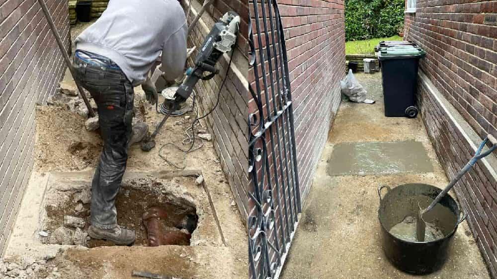 I'll create appropriate alt text for this before and after image of a drain repair in Bournemouth: "Before and after comparison of drain repair in Bournemouth completed by 1st Call Drainage, showing damaged pipe transformed to fully functional drainage system.