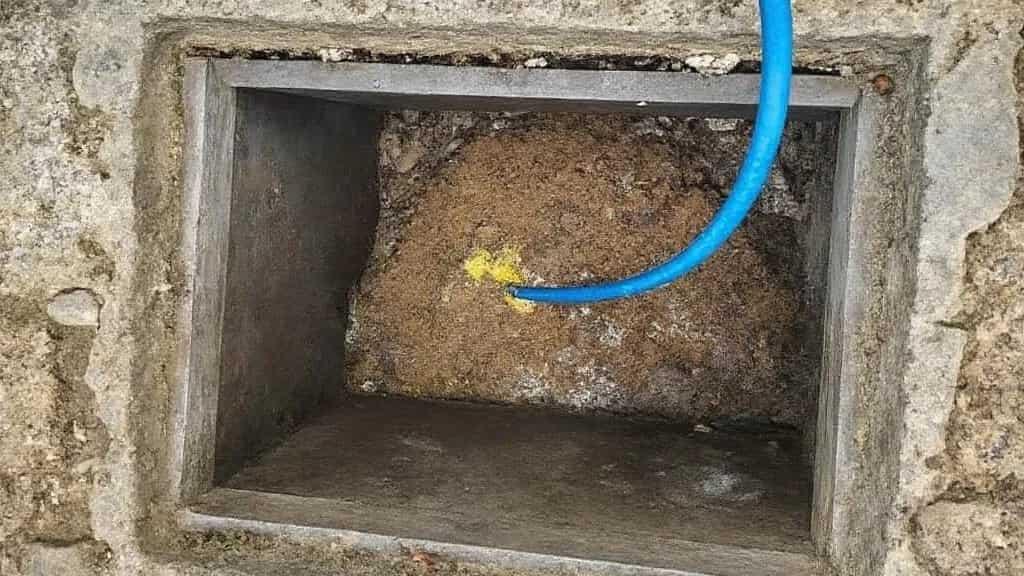 Blocked manhole being cleared with a jetting hose - professional drainage service in Bournemouth responding to blocked drain call