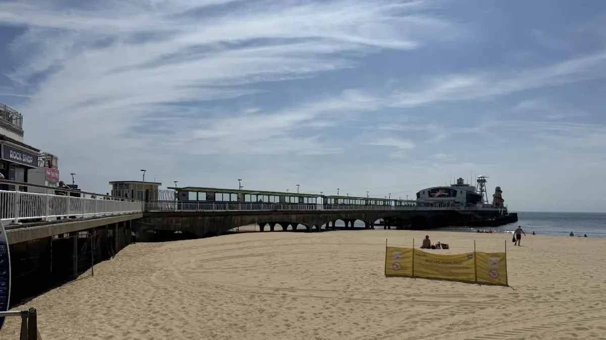 "General view of Bournemouth pier extending into the sea from the sandy beach.