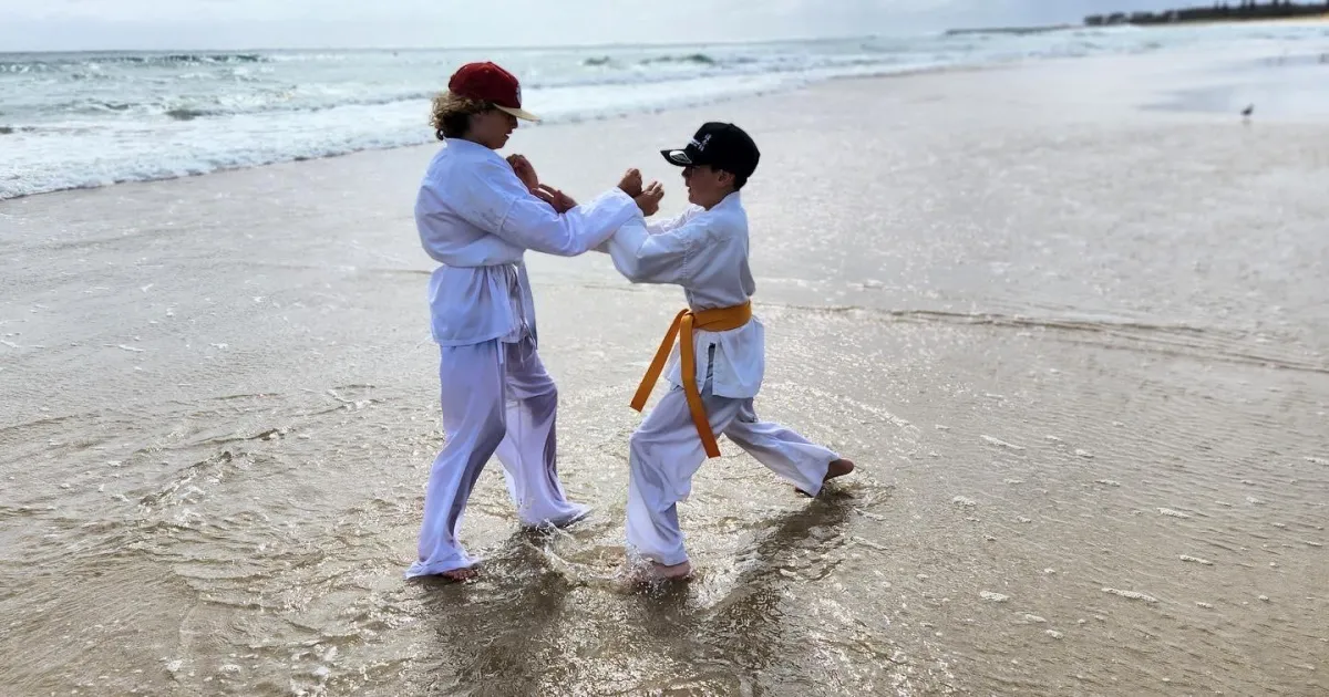 Two karate students doing a karate stunt