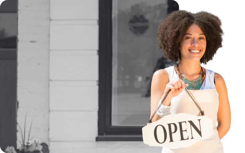Tenant holding an open sign after securing a commercial space through RSTM Properties leasing services.