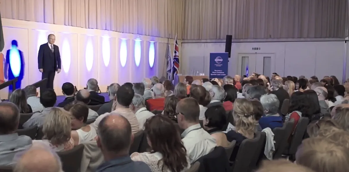 Jim J Davidson on stage with a room of property professionals
