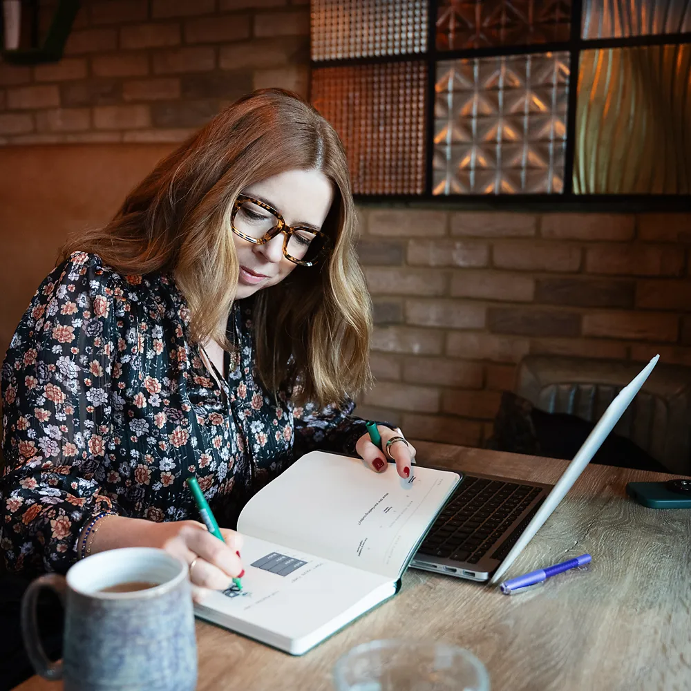 Ailsa Hichens writing in notebook