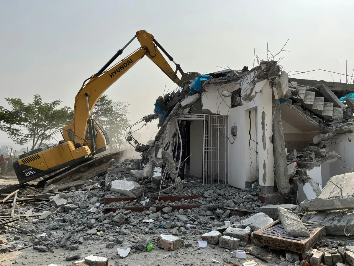 Controlled building demolition using heavy construction equipment