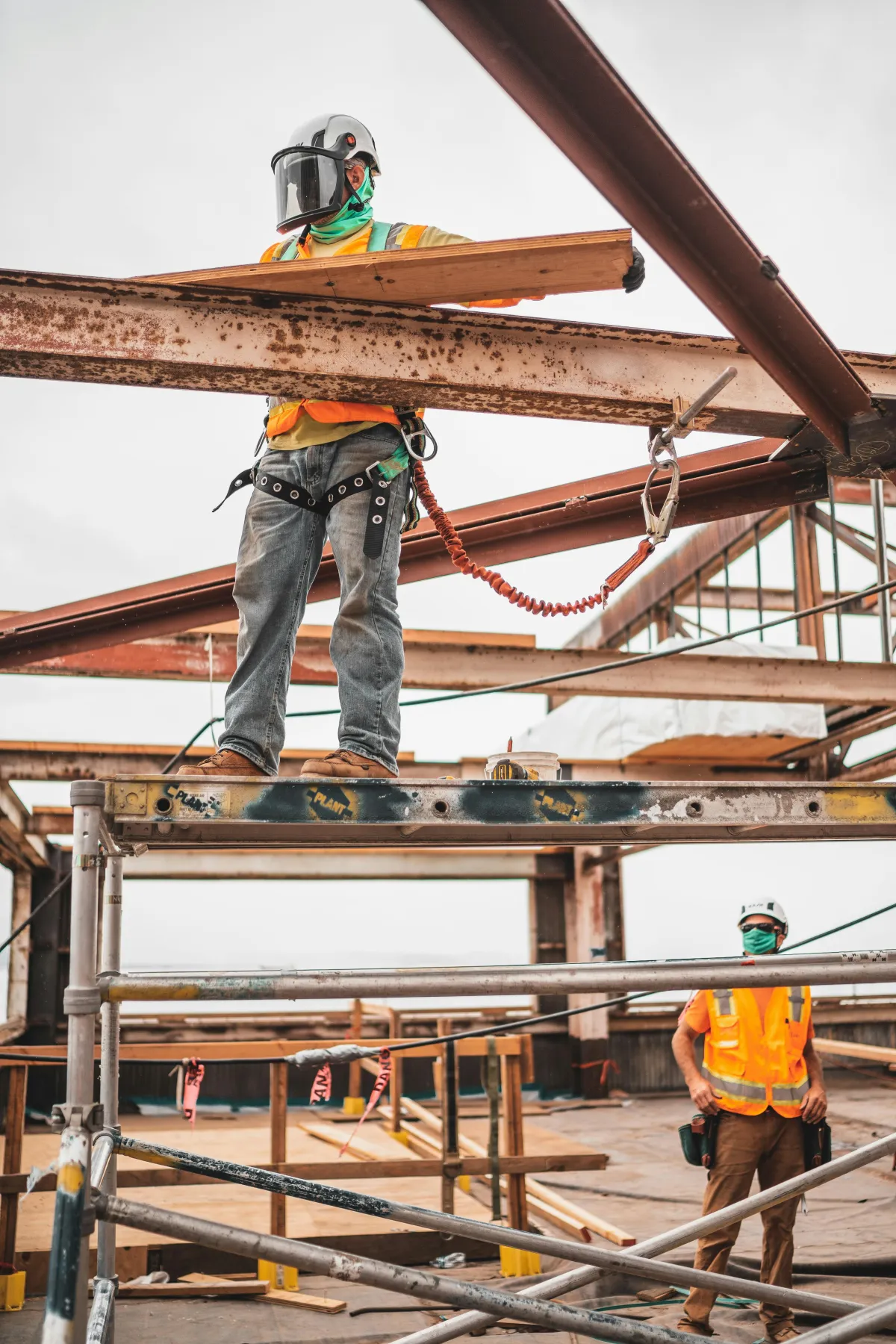 Roofing worker using fall protection on a construction project