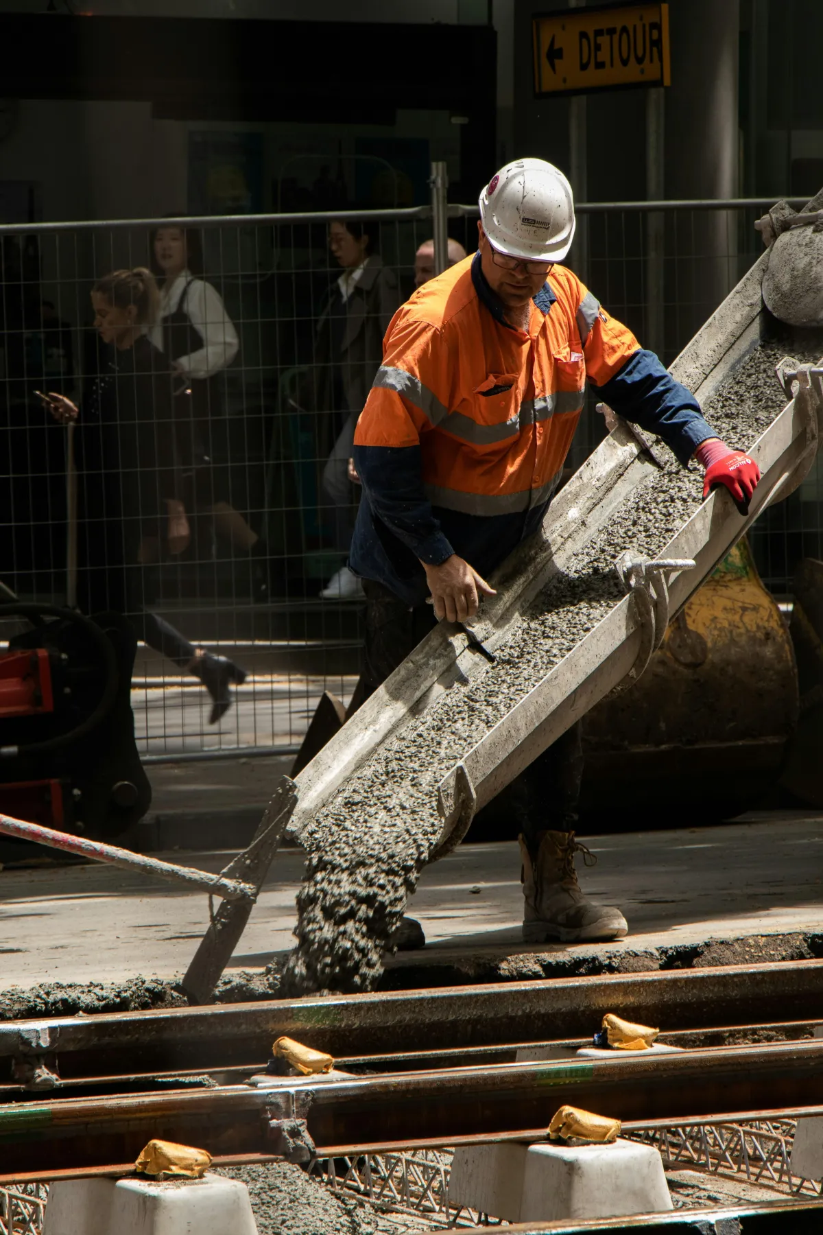 Construction worker placing concrete and performing masonry work