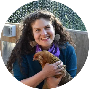 picture of woman smiling holding chicken