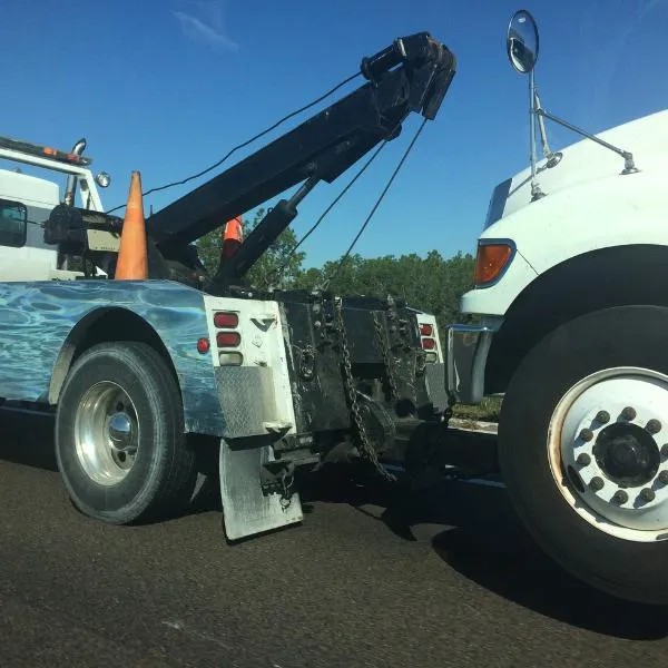 White car being towed by a tow truck