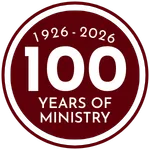 hands formed together with red heart paint