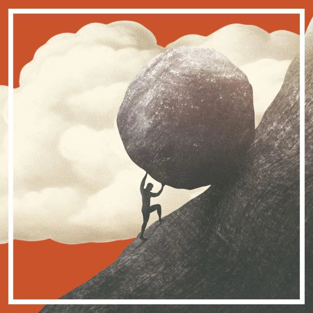 Image of man pushing a boulder up a hill