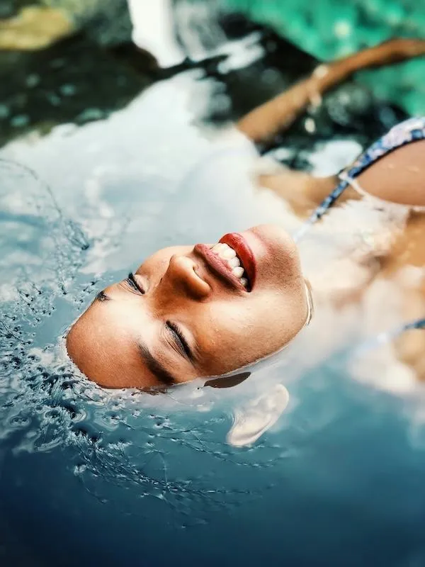 Photo of woman floating and relaxing in water