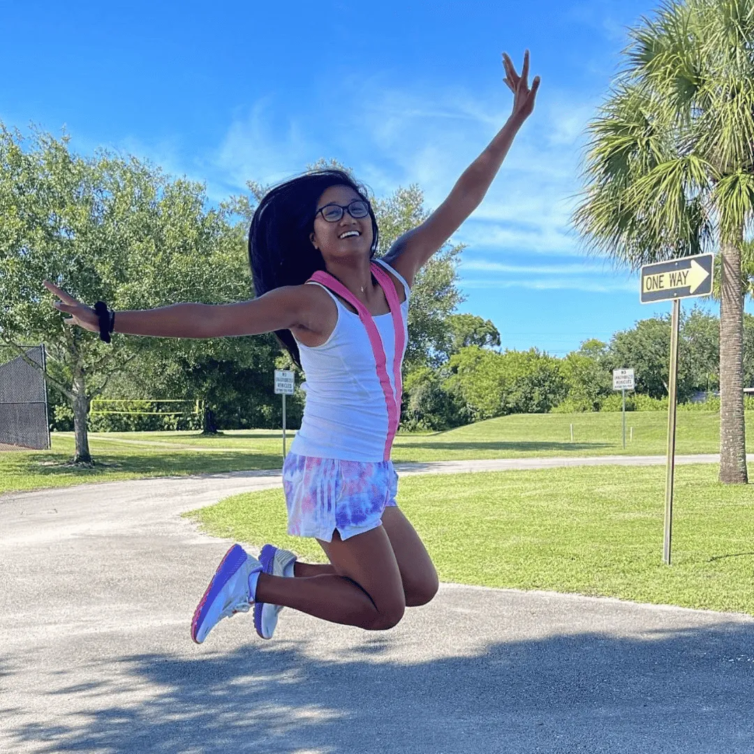 Michelle jumping outdoors, featured in her Health Boost Challenge testimonial