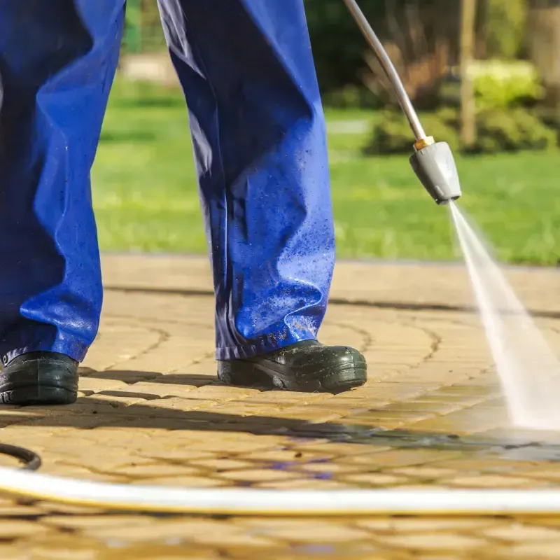 H2O Pressure Washing technician cleaning a driveway
