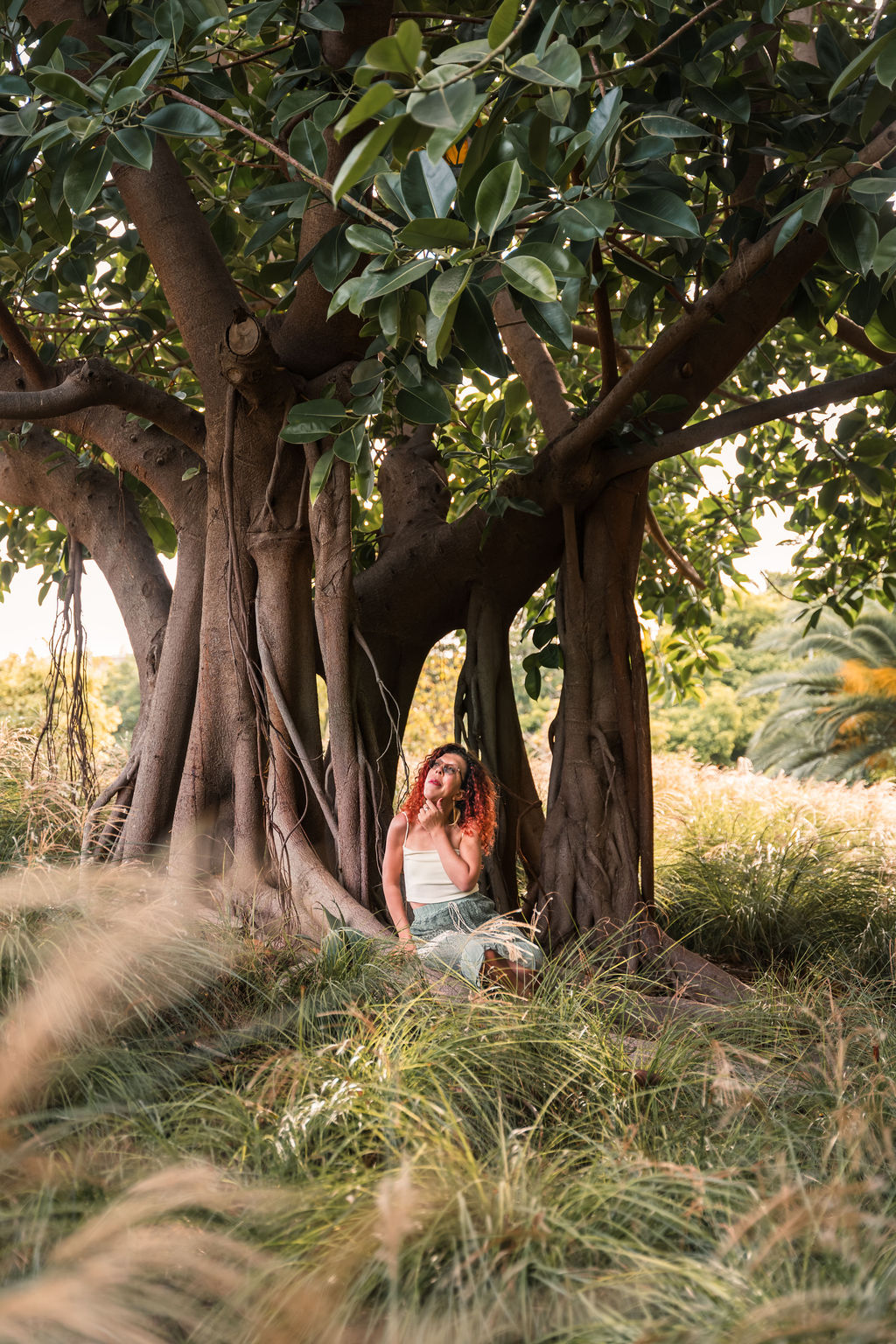 A woman tha sit in the grass – under a big, beautiful and powerful tree. Connected to herself, to Spirit and Universe, and to Mother Gaia – the nature.