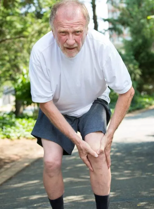 man bent over with knee pain