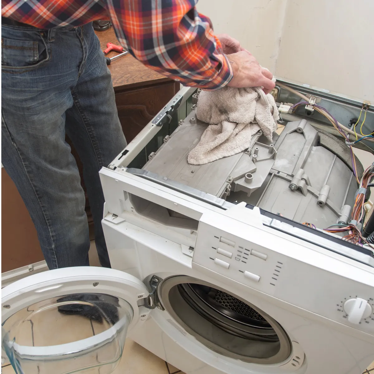 Apollo Appliance Repair - technician fixing a dryer in Huntsville, AL