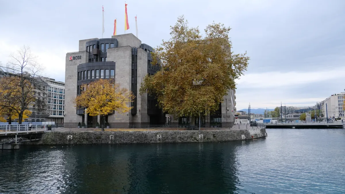 Immeuble de la Banque cantonale de Genève au bord du Rhône, sous un ciel gris d'automne
