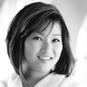 A close-up of a women with shoulder-length, straight hair,