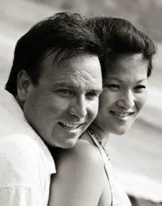 A close-up image of a couple embracing, with their heads close together
