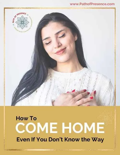 A woman in a white sweater lightly touches her chest, conveying warmth and introspection