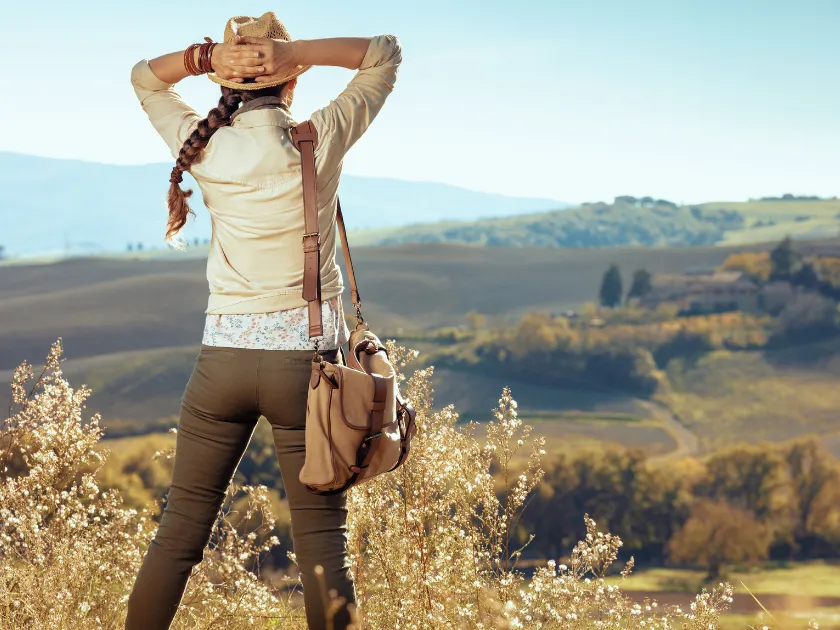 Woman sets out on a journey to restore her money situation, walking on a long path