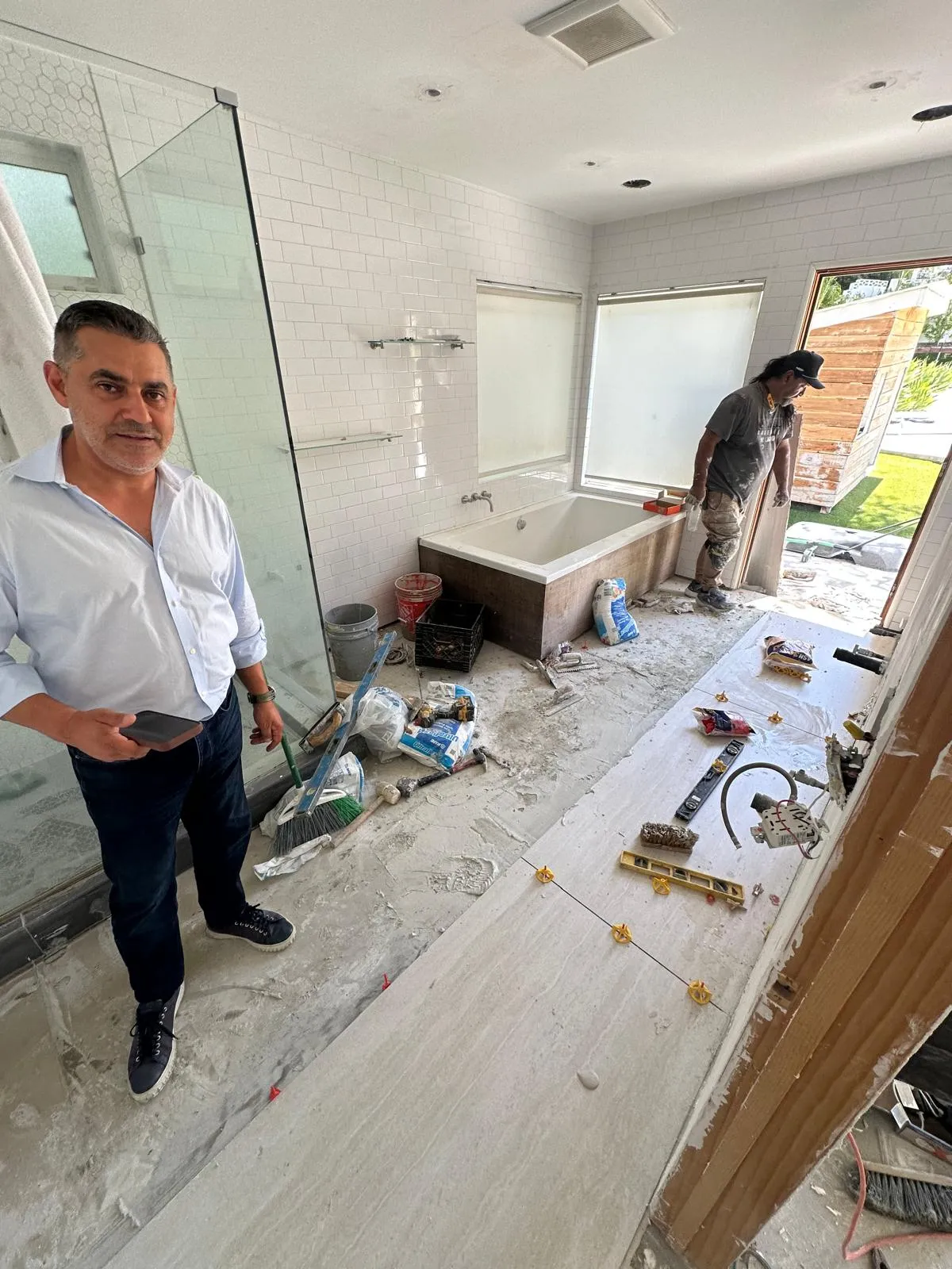 Bobby Zarabian inspecting architectural blueprints on a luxury estate site