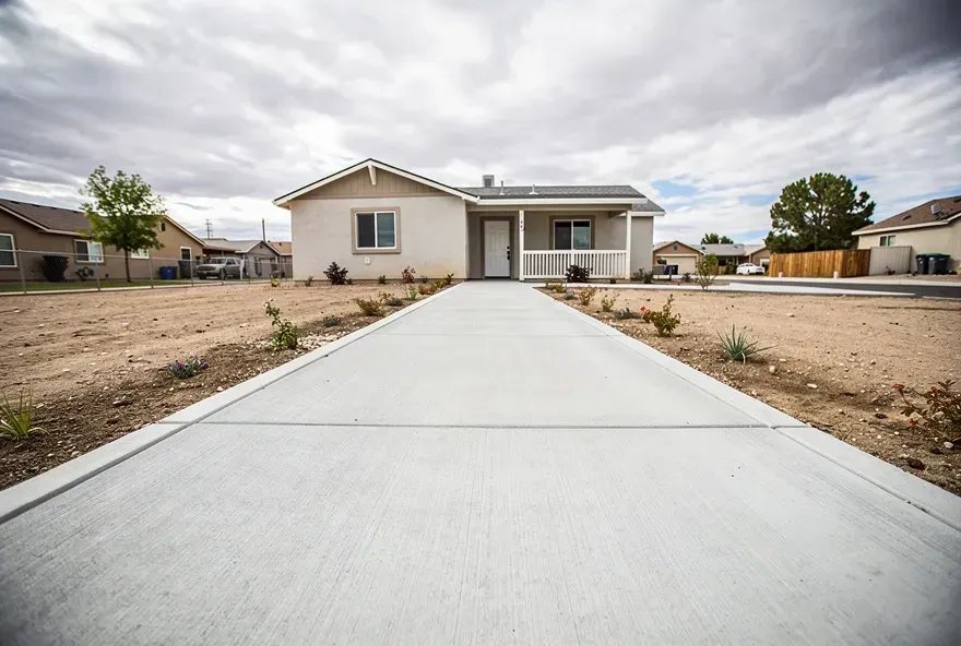 Freshly poured concrete sidewalk in front of a Lancaster, CA home