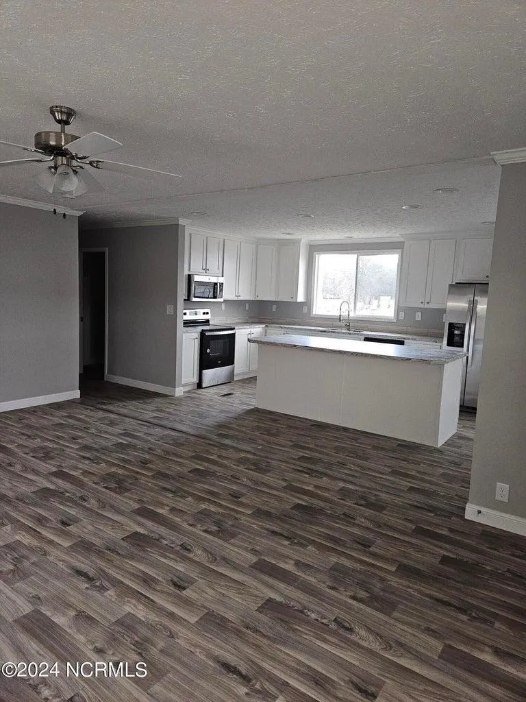 Living room and kitchen area of a brand new home