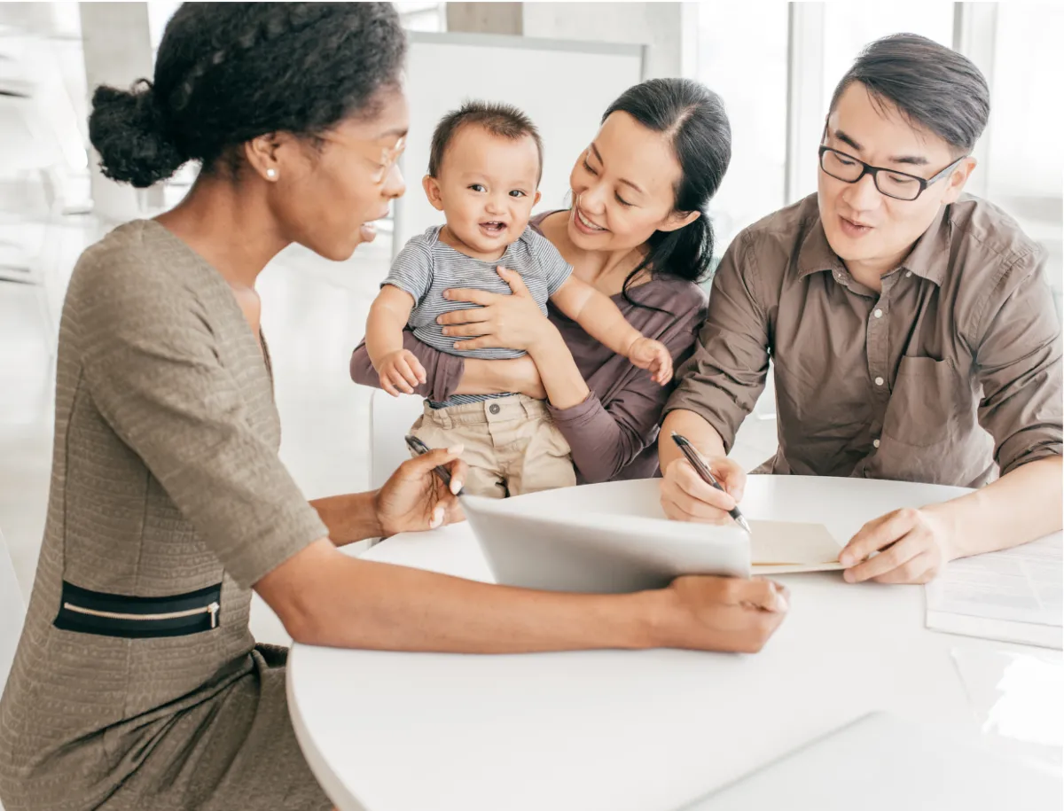 Three professionals discussing charts in a meeting.