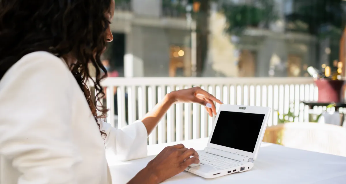 A diverse team of business professionals collaborating around a glass board filled with strategy diagrams and notes. The environment is open, modern, and filled with natural light, highlighting teamwork and forward-thinking.