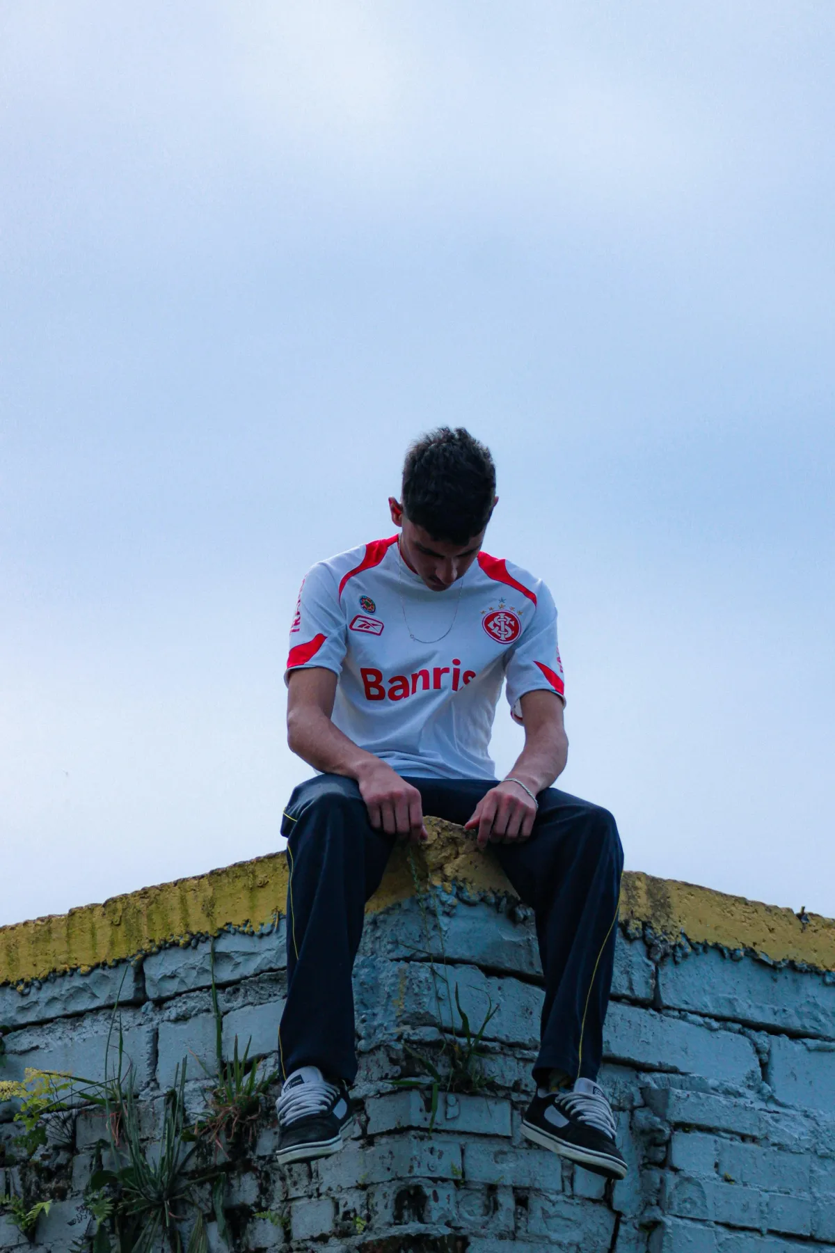 Young athlete sitting alone in thought — anxiety and overthinking in sports