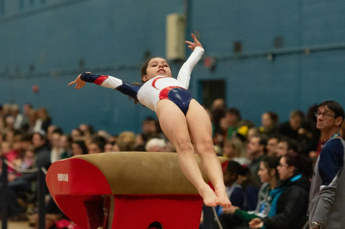 Gymnast competing in front of a crowd — performance pressure in sports