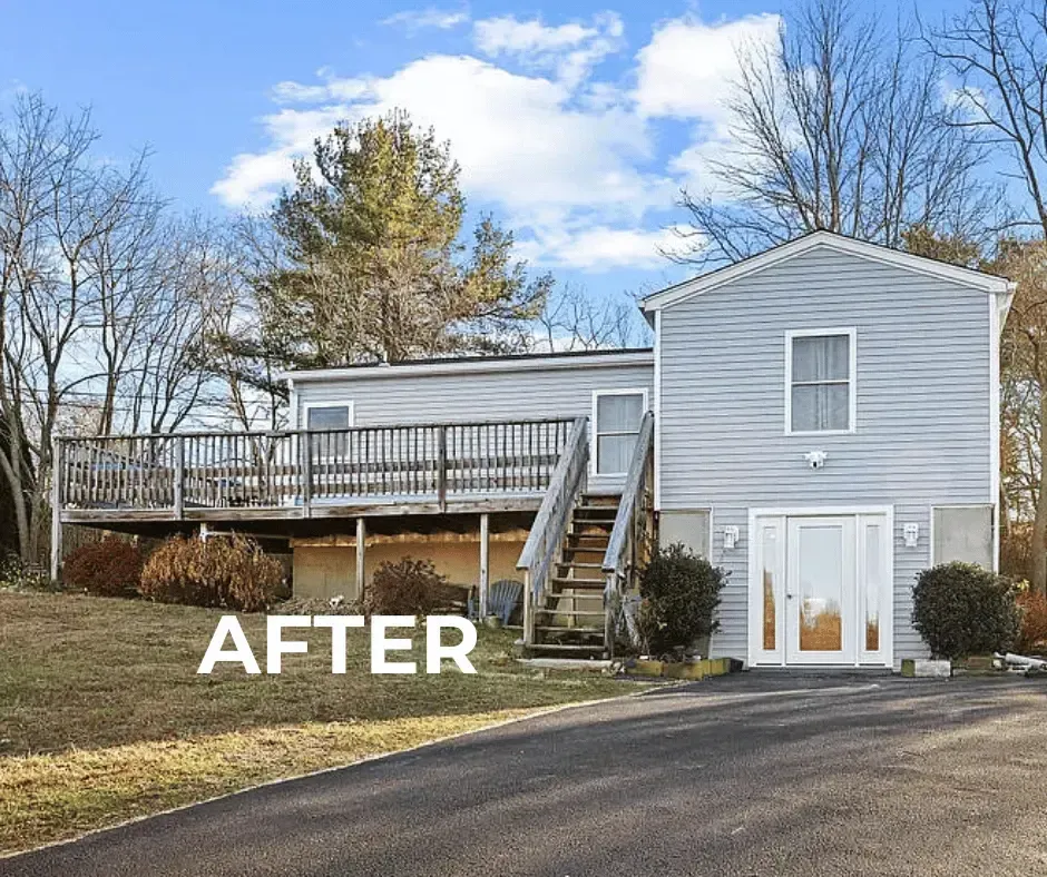 Completed home exterior remodeling project by KMAX Renovations featuring new light gray siding, refreshed deck, and clean paved asphalt driveway in Connecticut