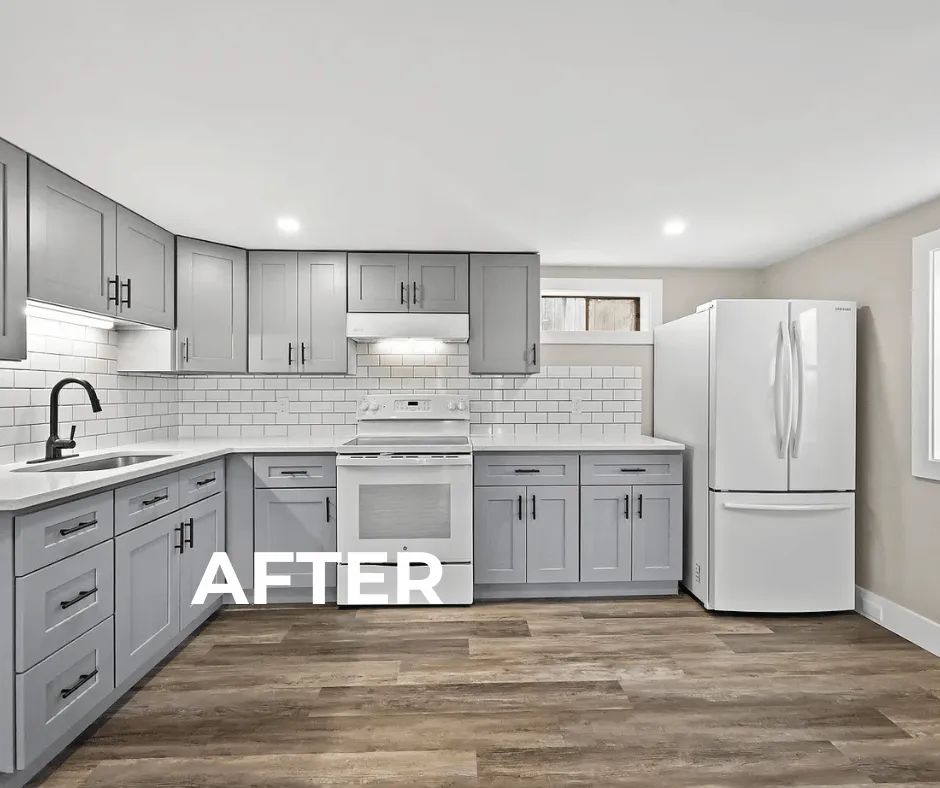 Finished Connecticut open-plan basement apartment, featuring a modern kitchen with grey shaker cabinets, white quartz countertops, subway tile backsplash, recessed LED lighting, and light wood-look luxury vinyl plank (LVP) flooring.